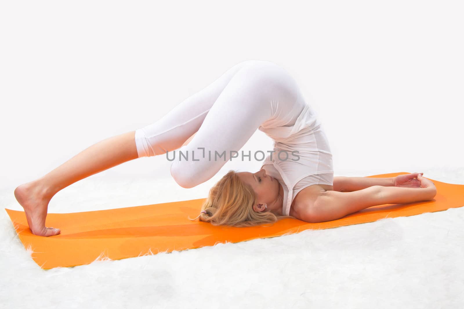 Young beautiful girl is professionally engaged in yoga  by NickNick