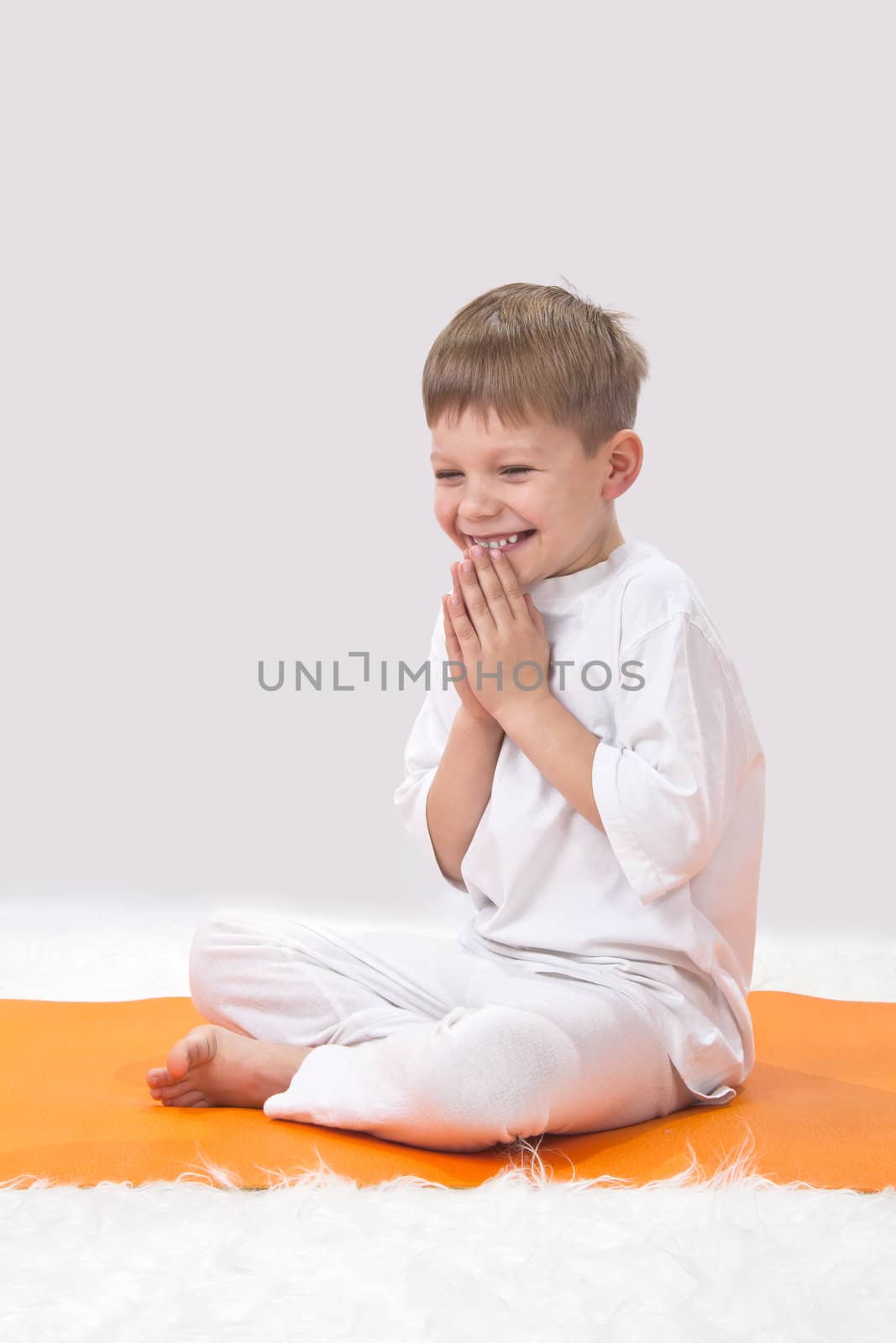 Children's yoga. The little boy does exercise. 