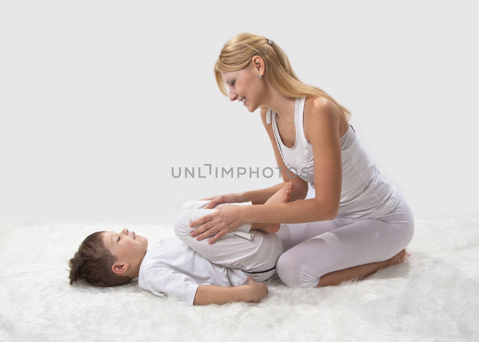 Mother and son do yoga before bed by NickNick