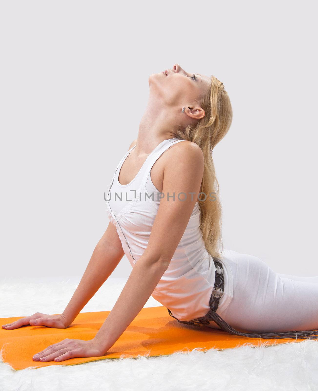 Young beautiful girl is professionally engaged in yoga 