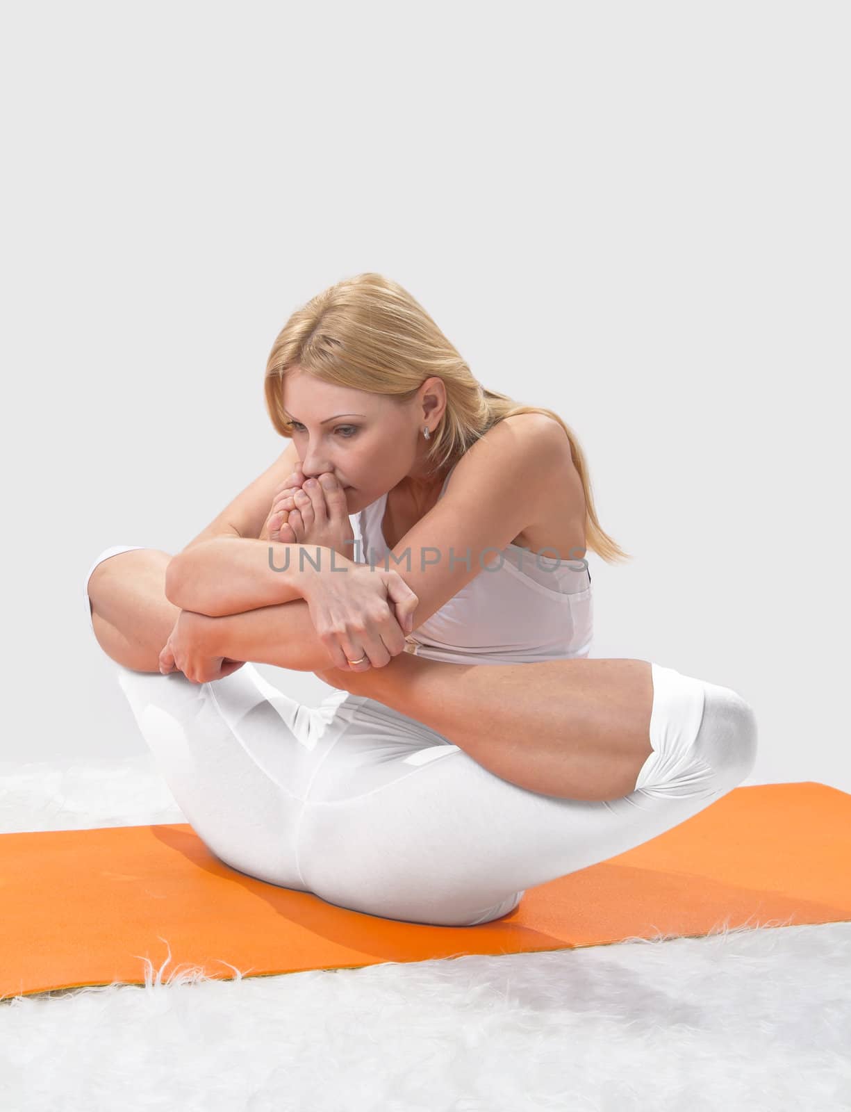 Young beautiful girl is professionally engaged in yoga 