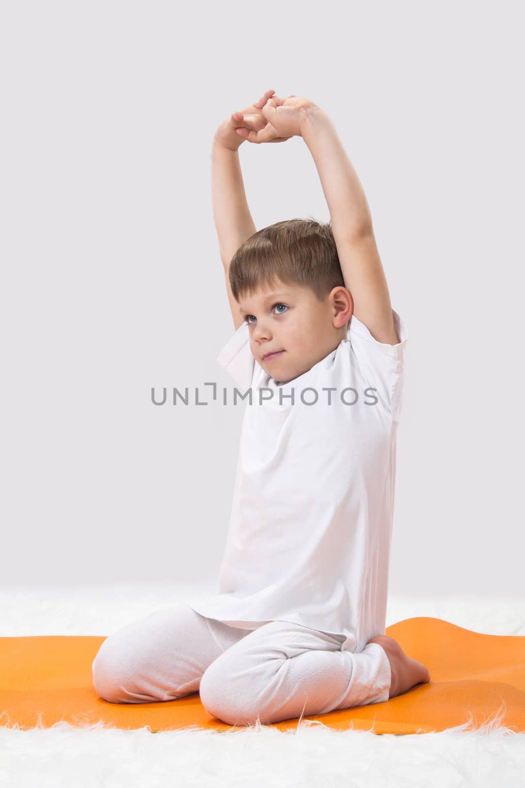 Children's yoga. The little boy does exercise. 