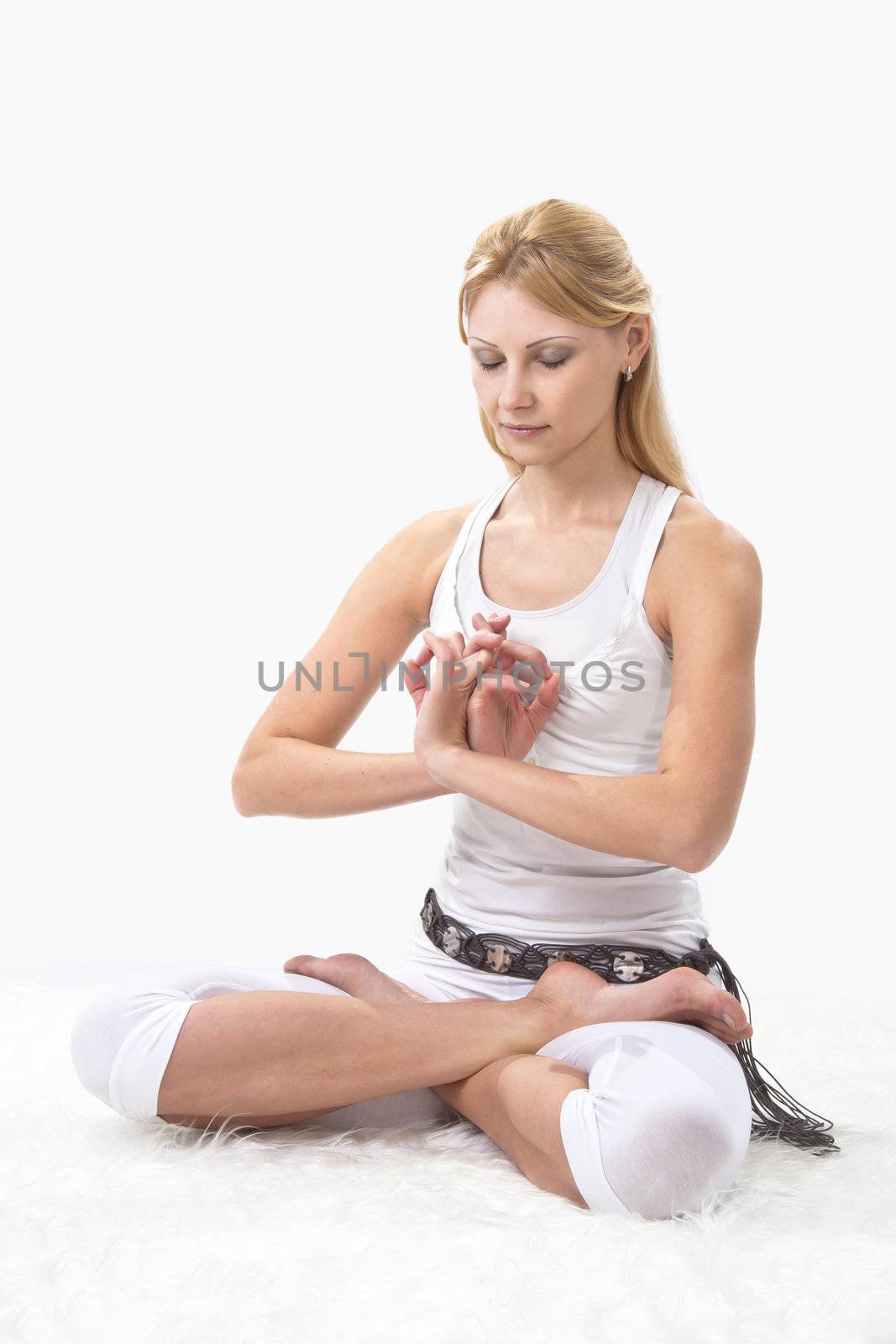 Young beautiful girl is professionally engaged in yoga by NickNick