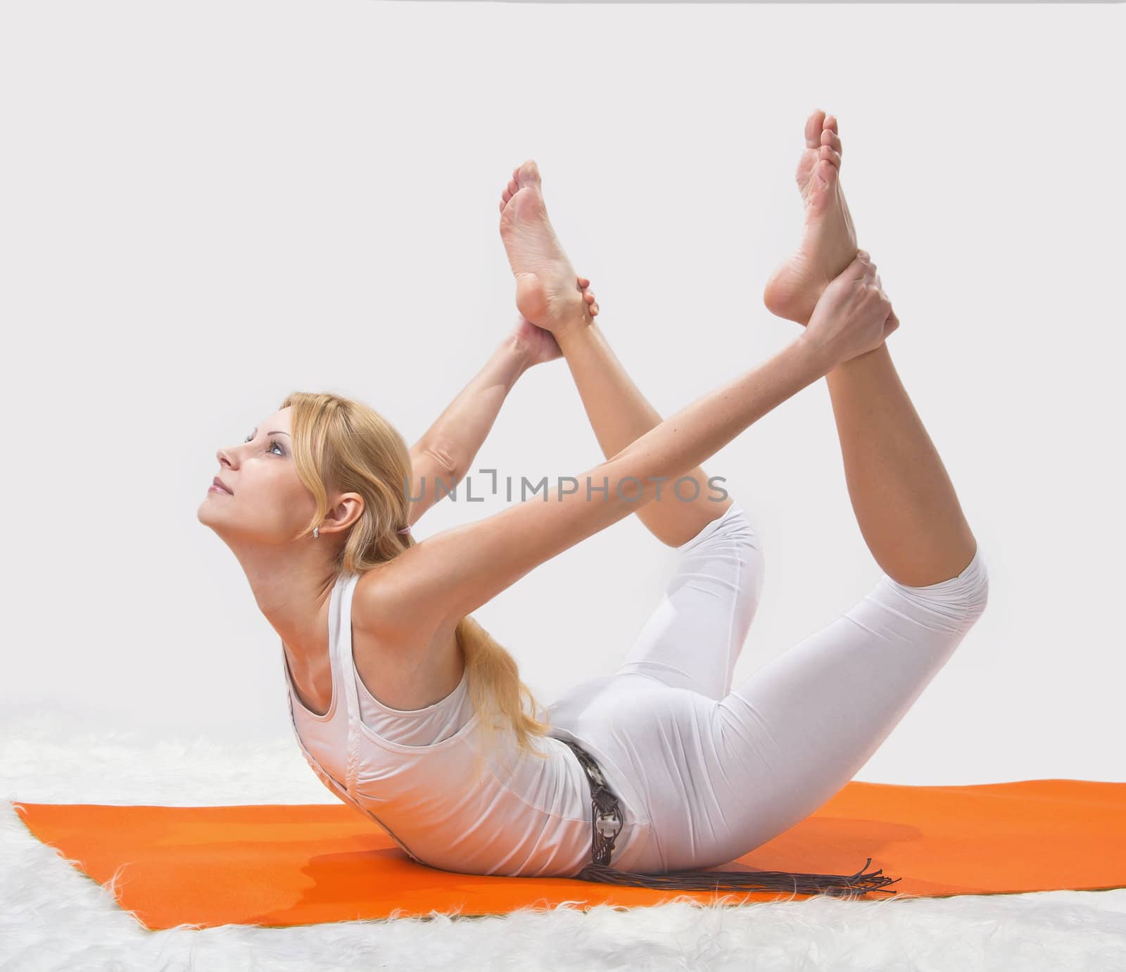 Young beautiful girl is professionally engaged in yoga 