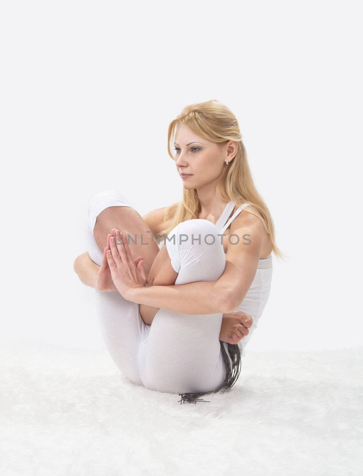 Young beautiful girl is professionally engaged in yoga 