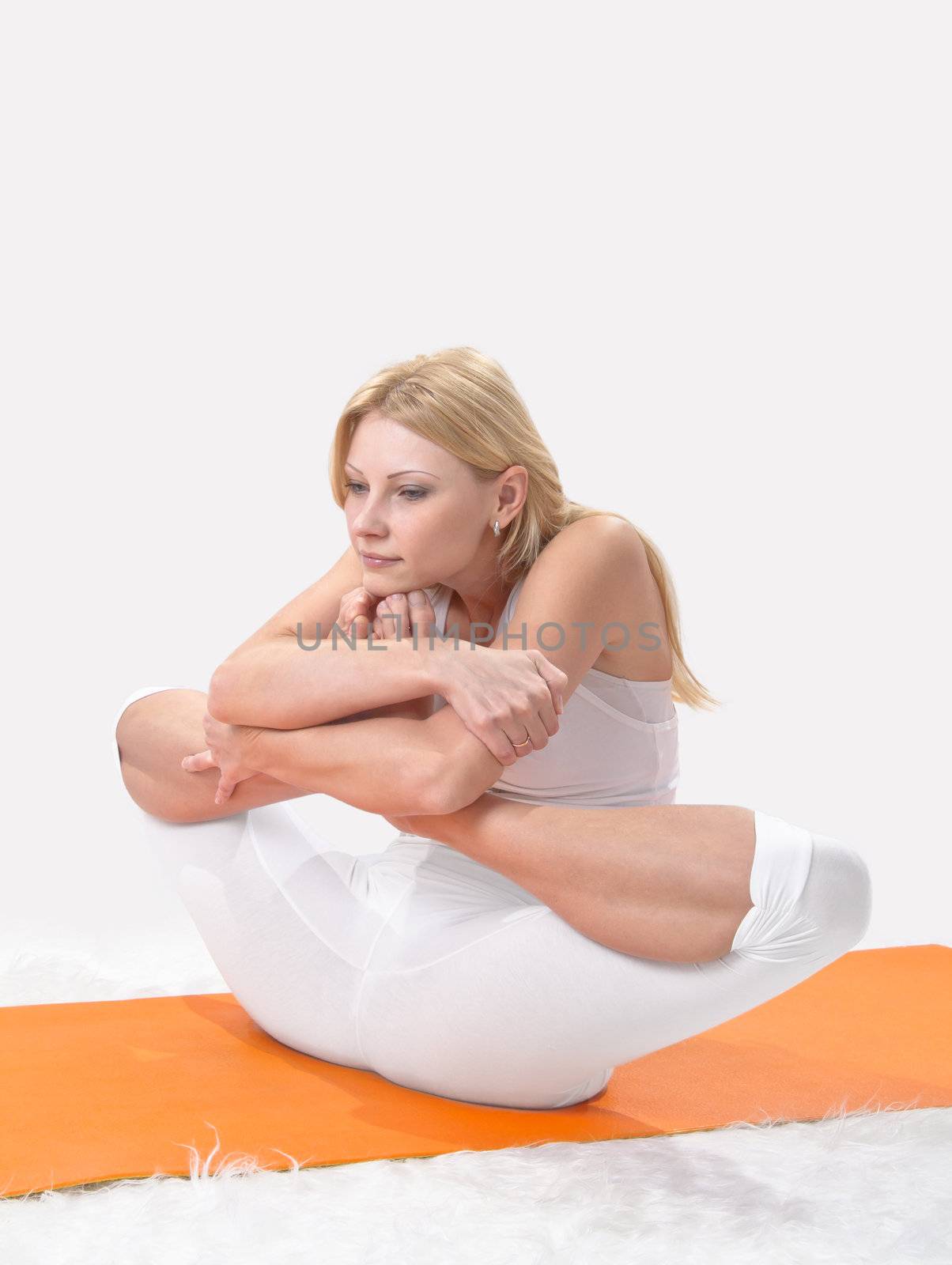 Young beautiful girl is professionally engaged in yoga 