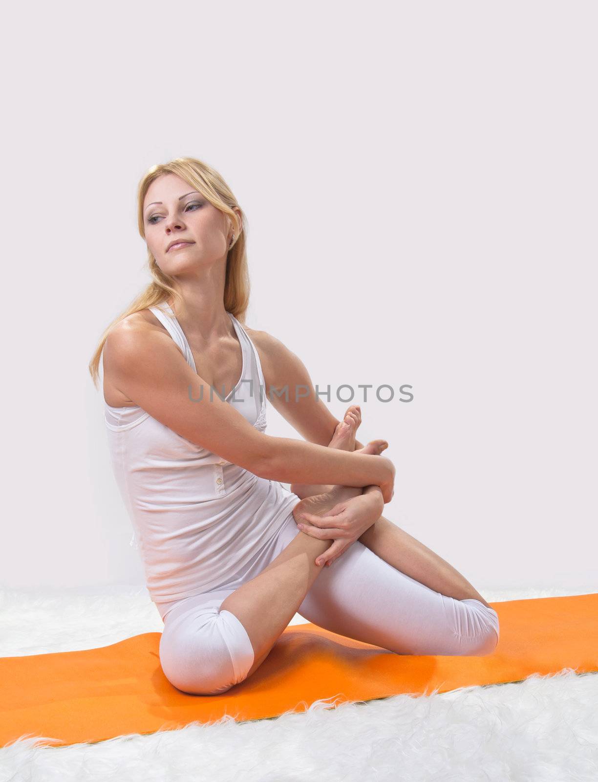 Young beautiful girl is professionally engaged in yoga 