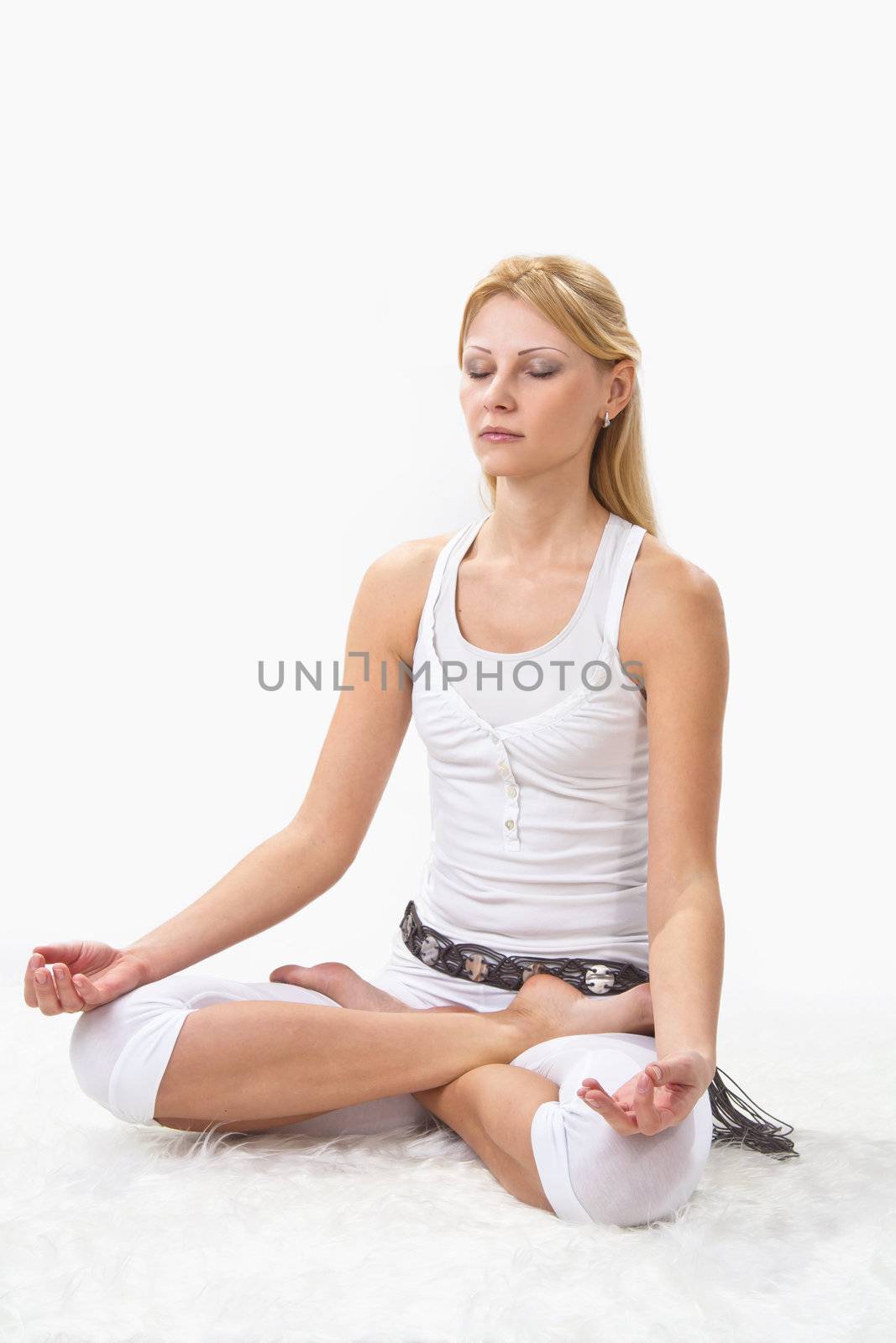 Young beautiful girl is professionally engaged in yoga 