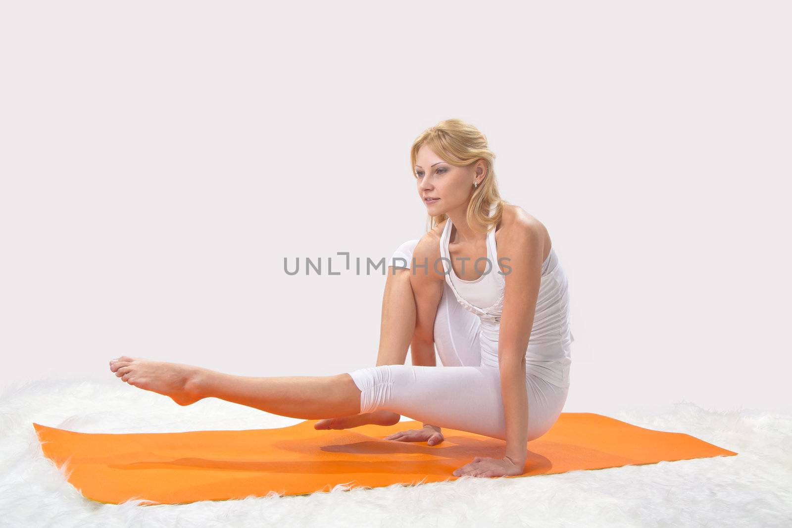 Young beautiful girl is professionally engaged in yoga 