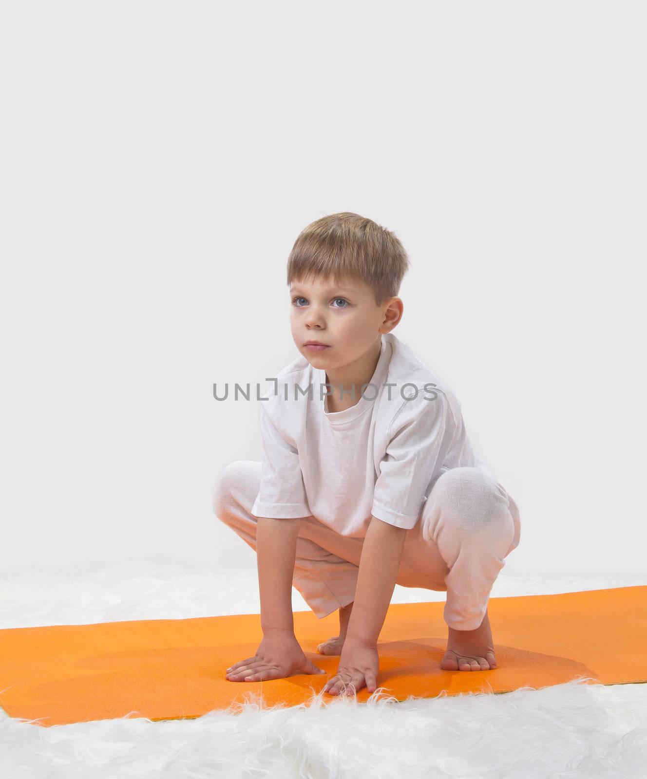 Children's yoga. The little boy does exercise. 