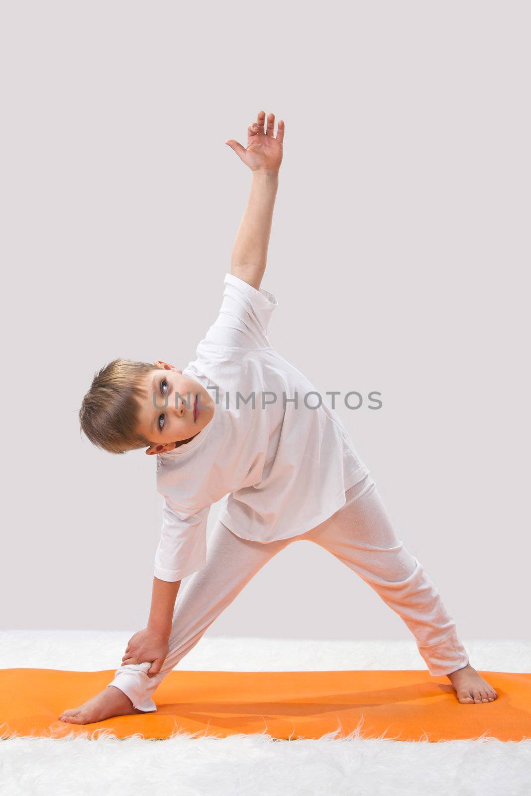 Children's yoga. The little boy does exercise. 