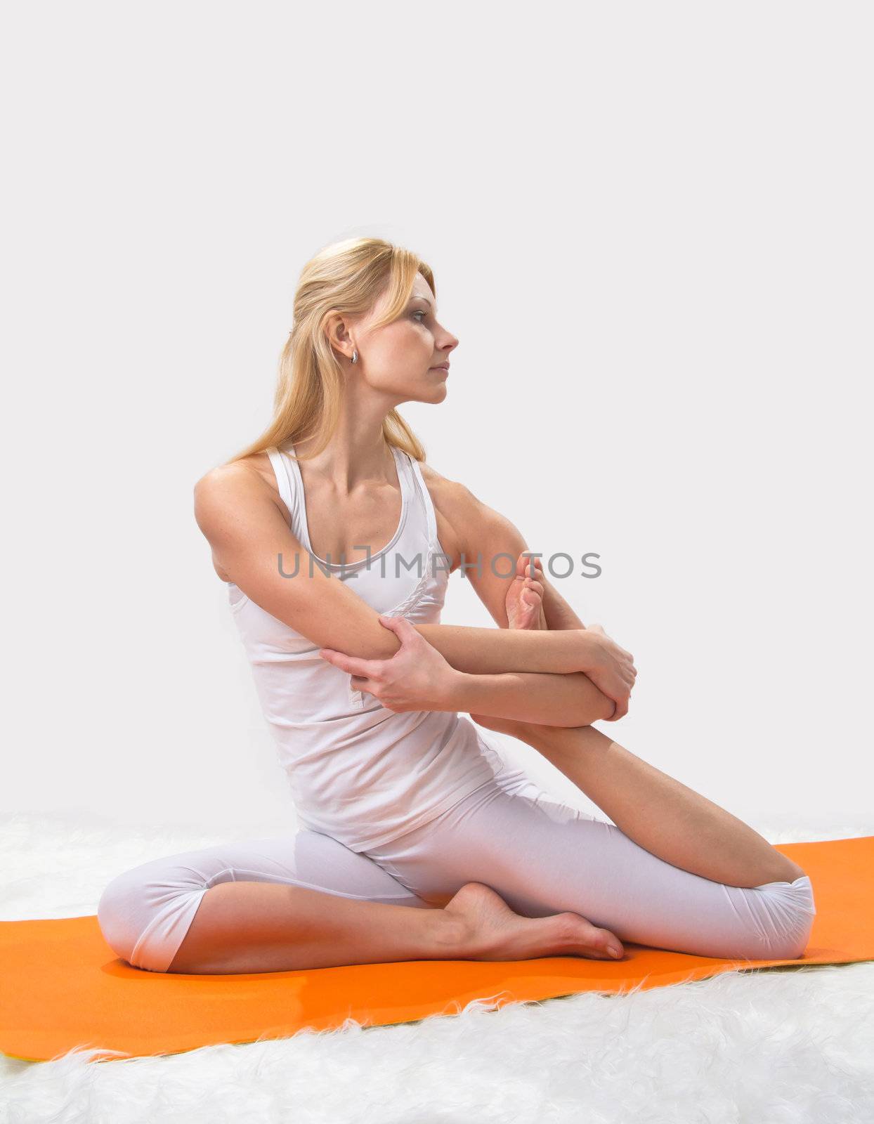 Young beautiful girl is professionally engaged in yoga  by NickNick