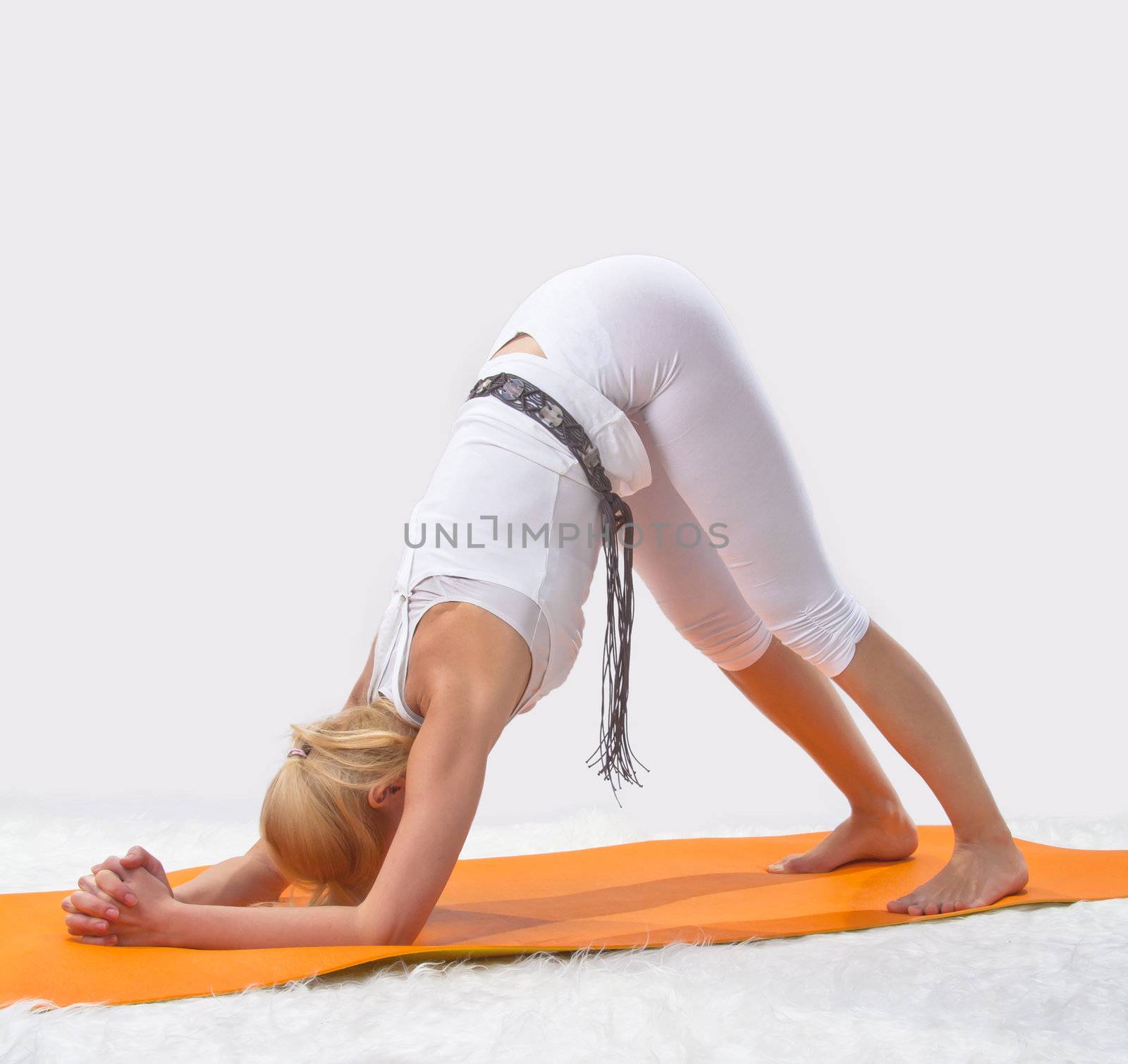 Young beautiful girl is professionally engaged in yoga  by NickNick