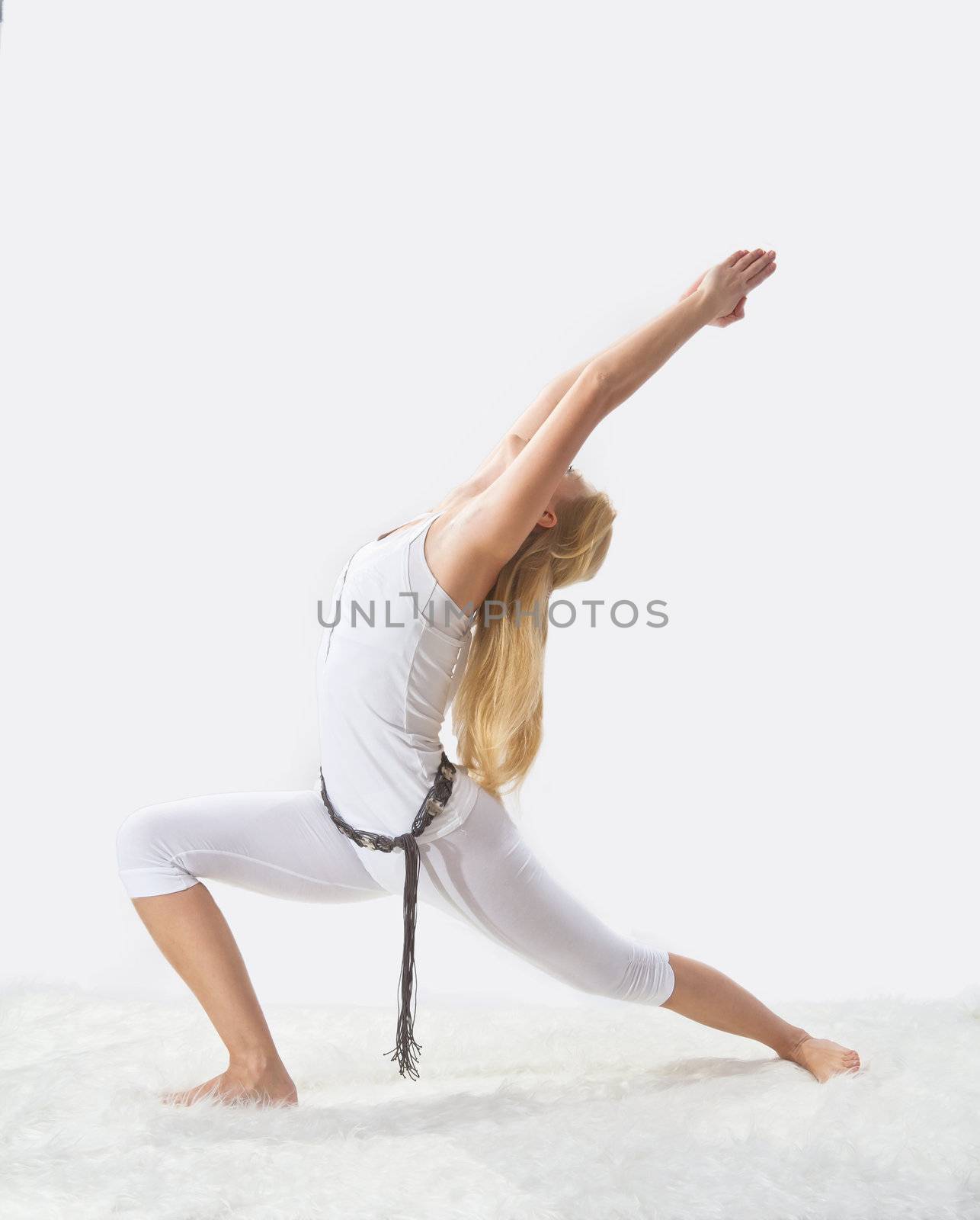 Young beautiful girl is professionally engaged in yoga  by NickNick