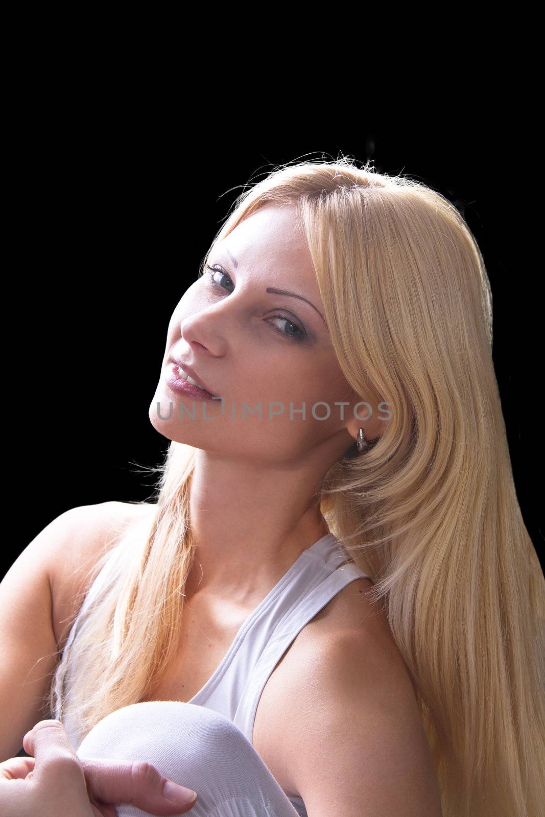 Portrait of a beautiful blonde on a dark background 