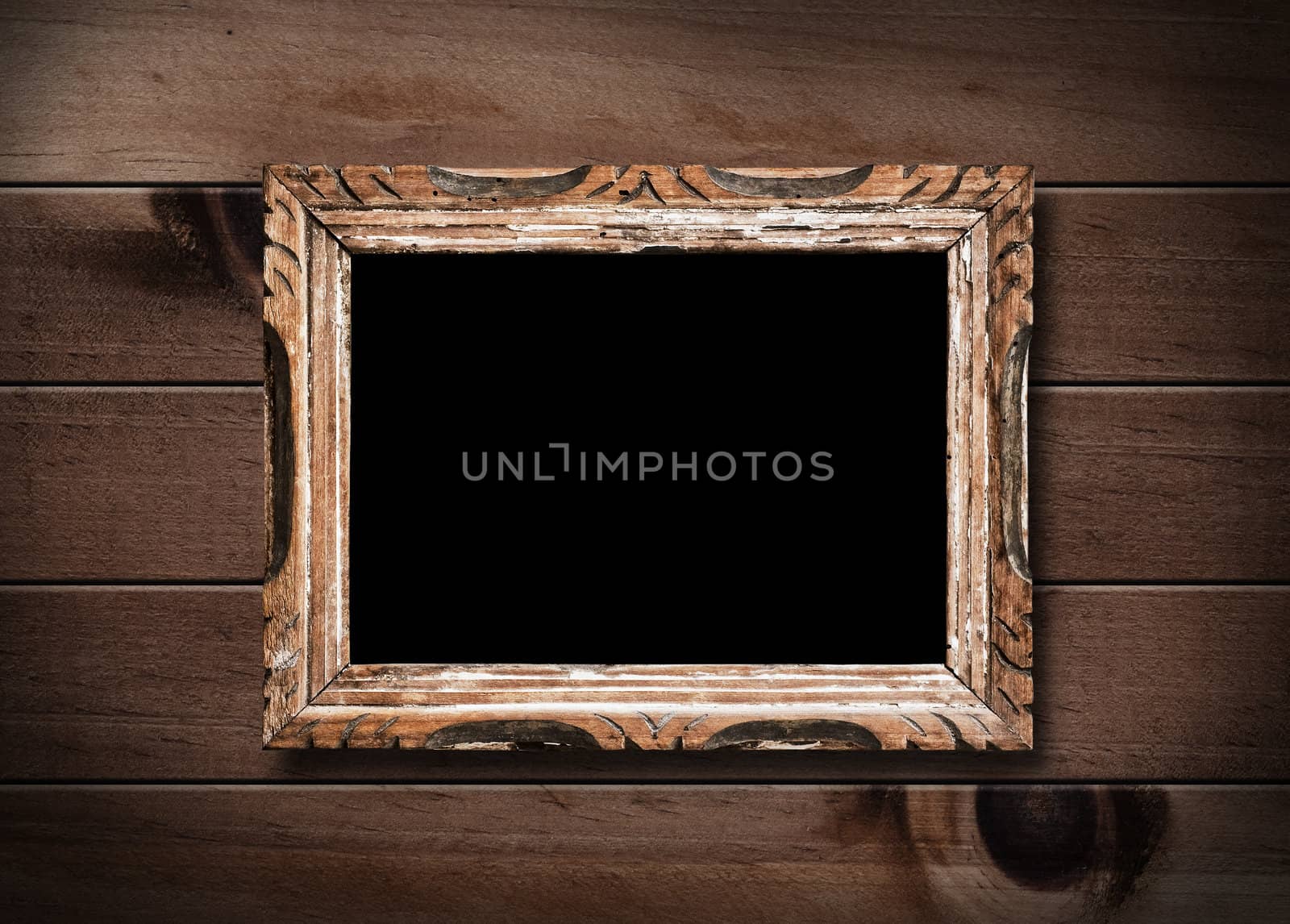 Vintage picture frame, blank, on wooden wall.