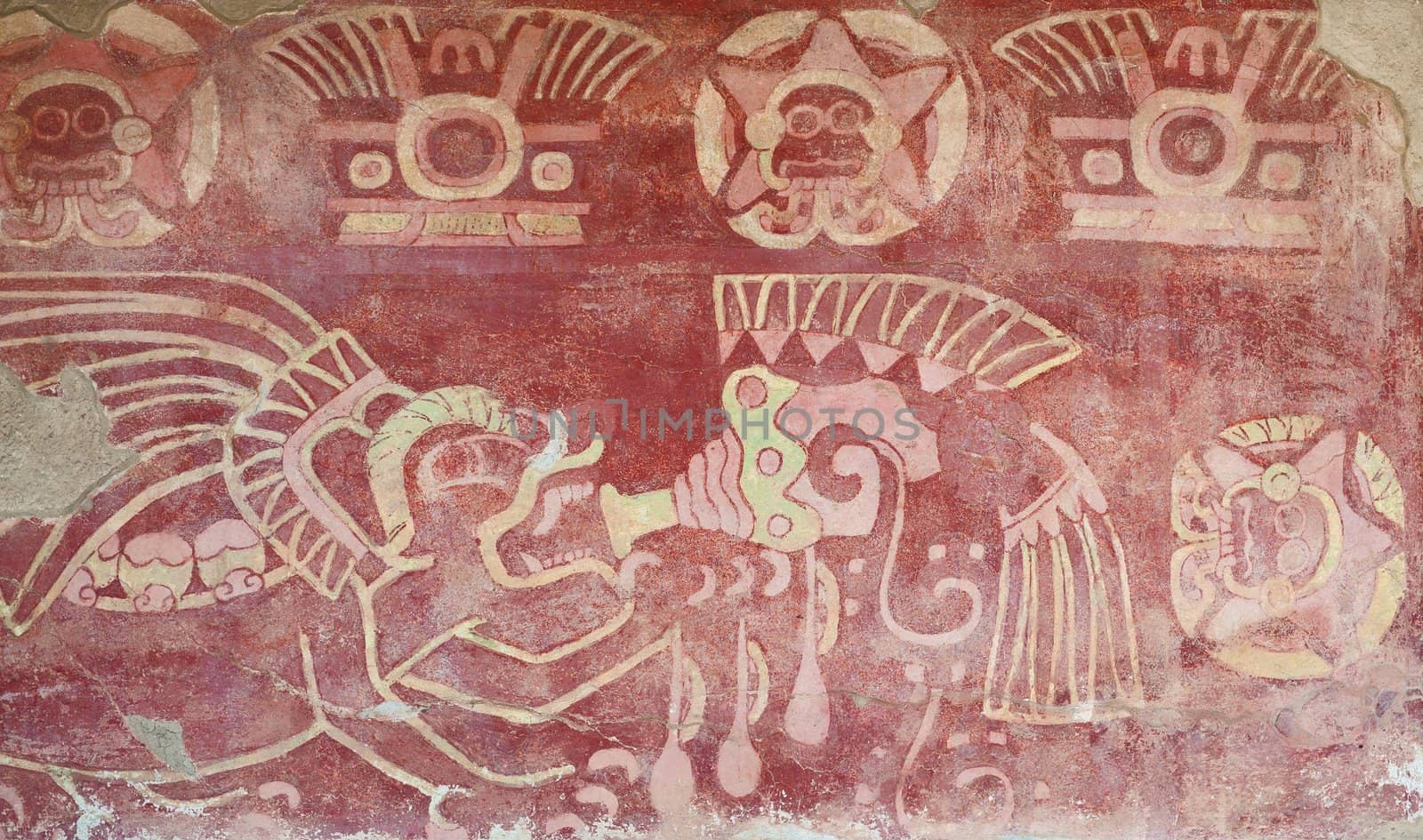 Interior of a temple in Teotihuacan, Mexico, with religious figures painted in a wall.