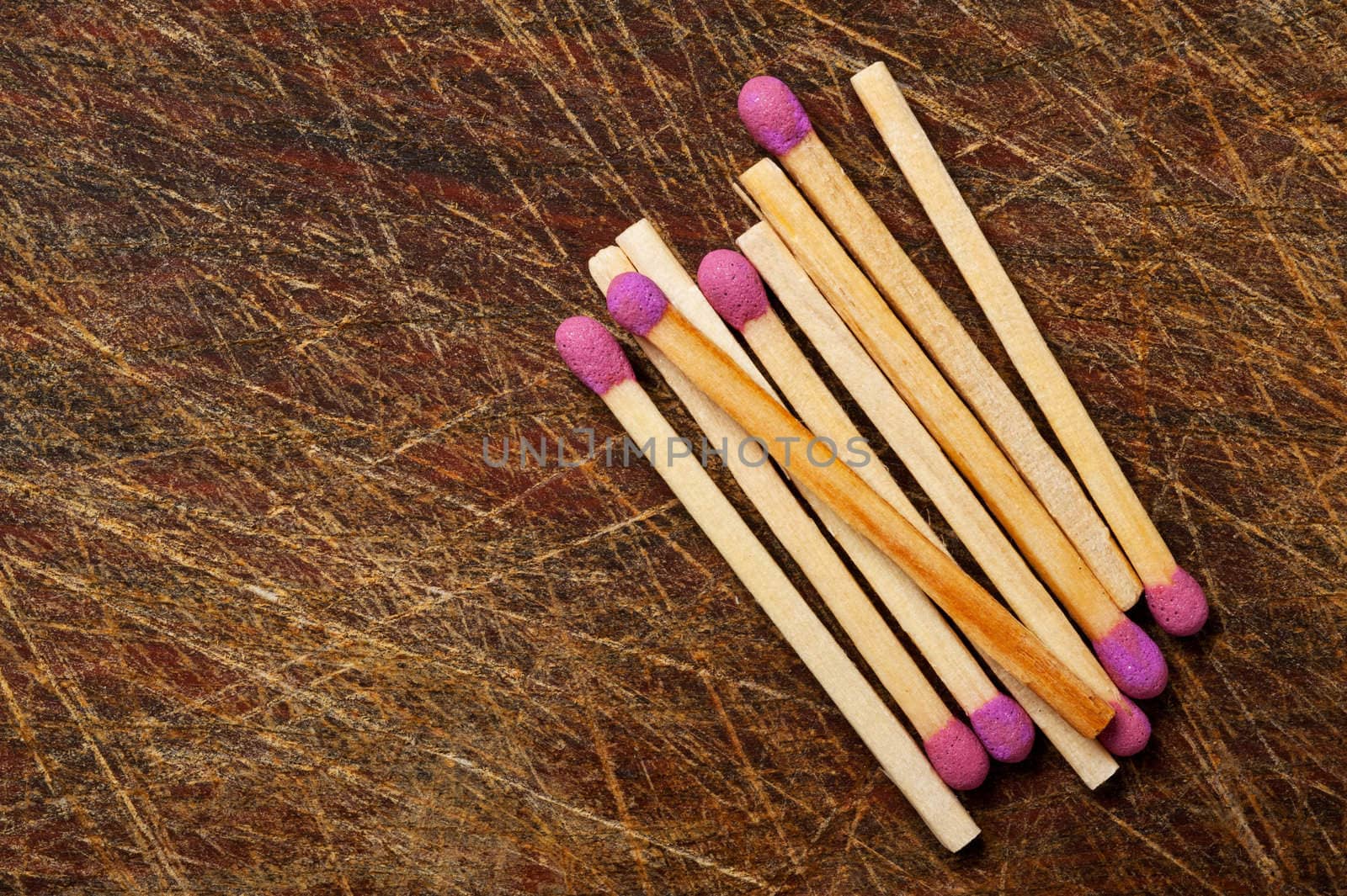 Group of matches on wooden table.