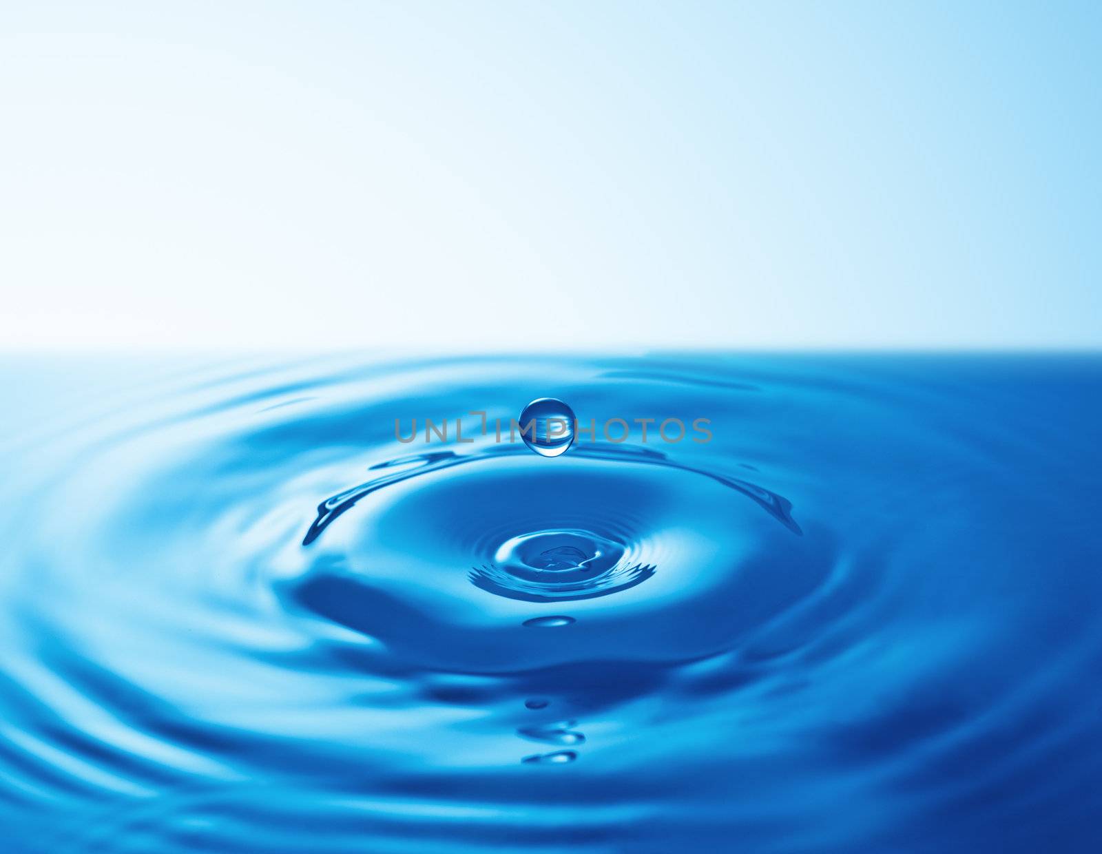 Falling Drop of water on blue. 