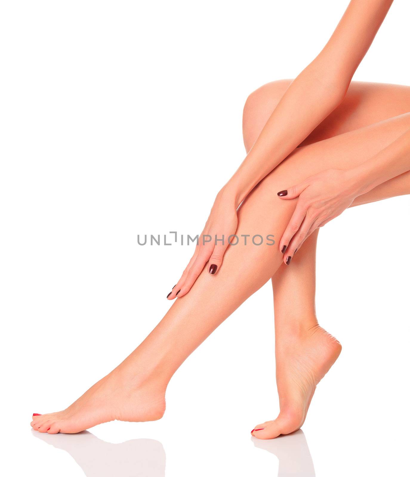 care for beautiful woman body. Perfect long female legs against white background