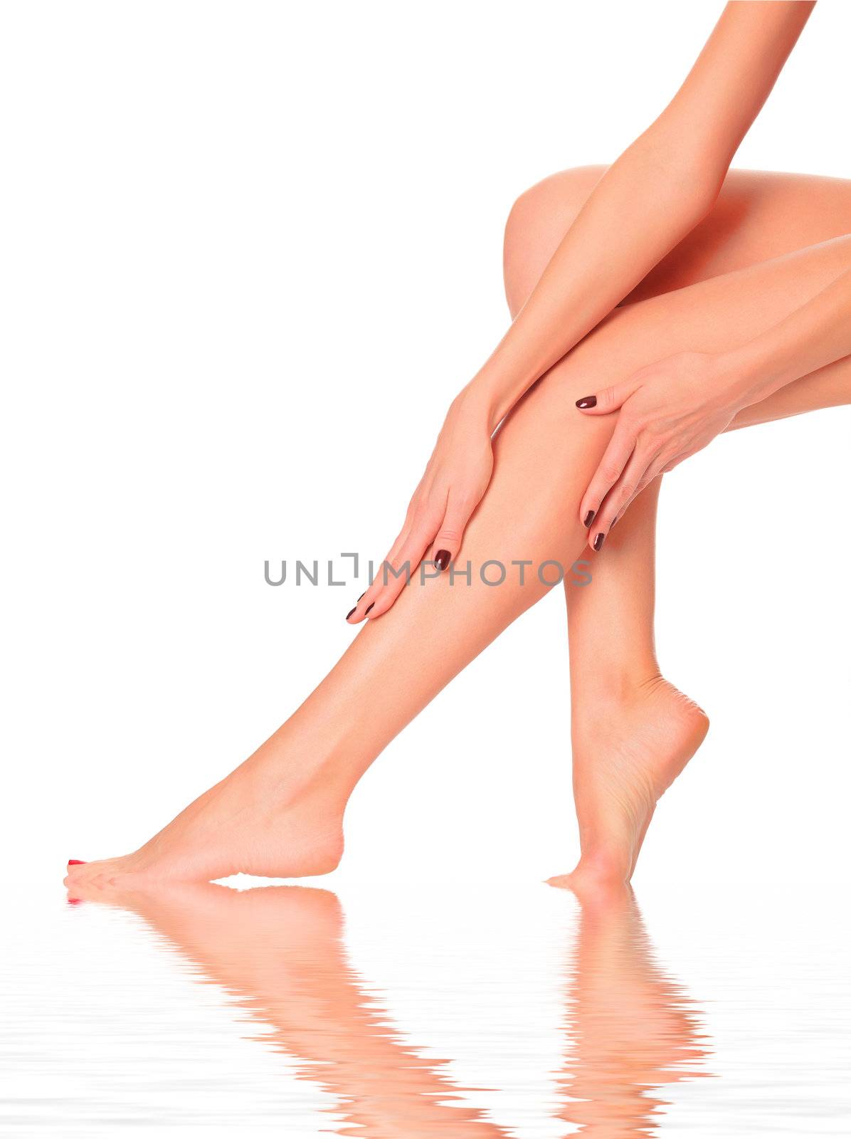 care for beautiful woman body. Perfect long female legs against white background