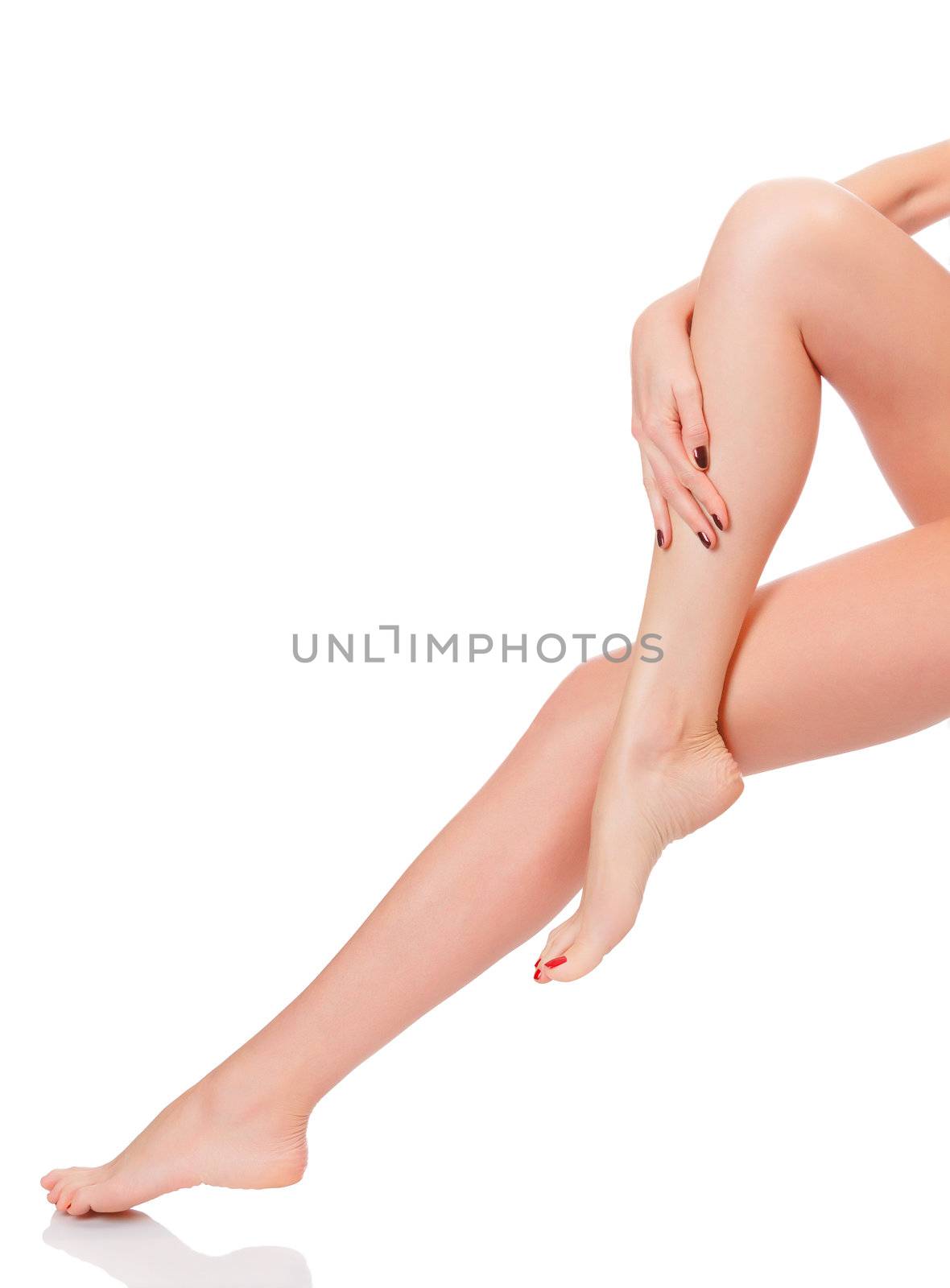 care for beautiful woman body. Perfect long female legs against white background