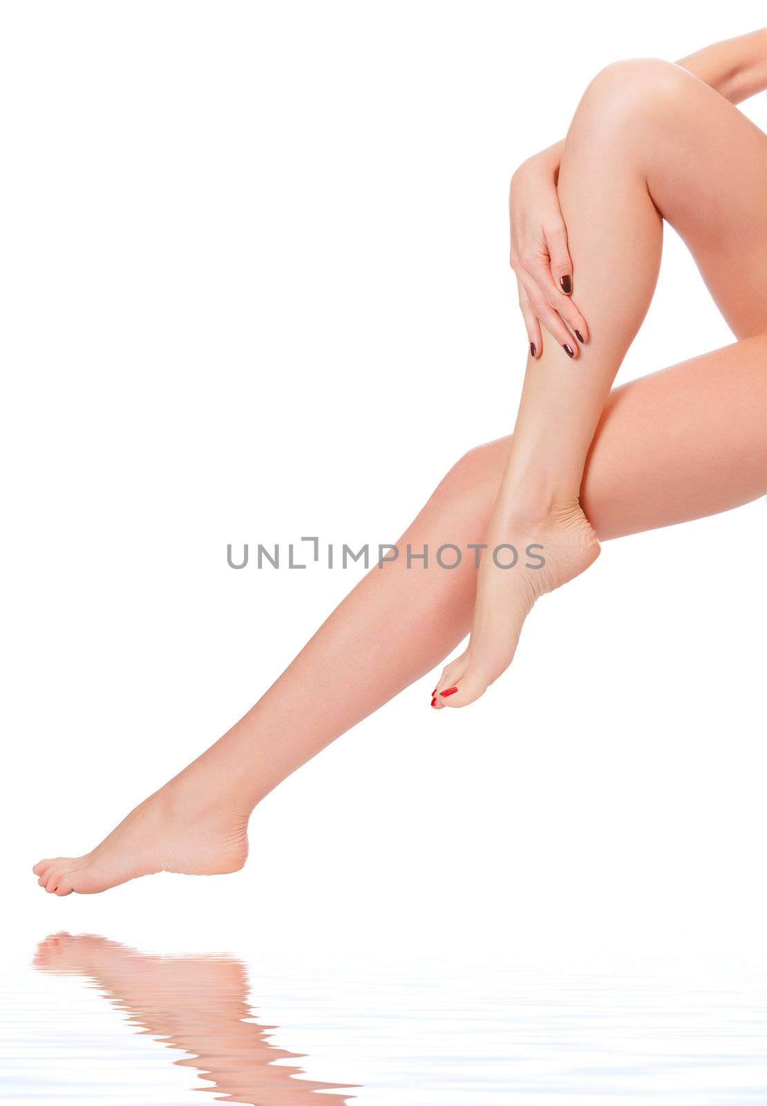 care for beautiful woman body. Perfect long female legs against white background