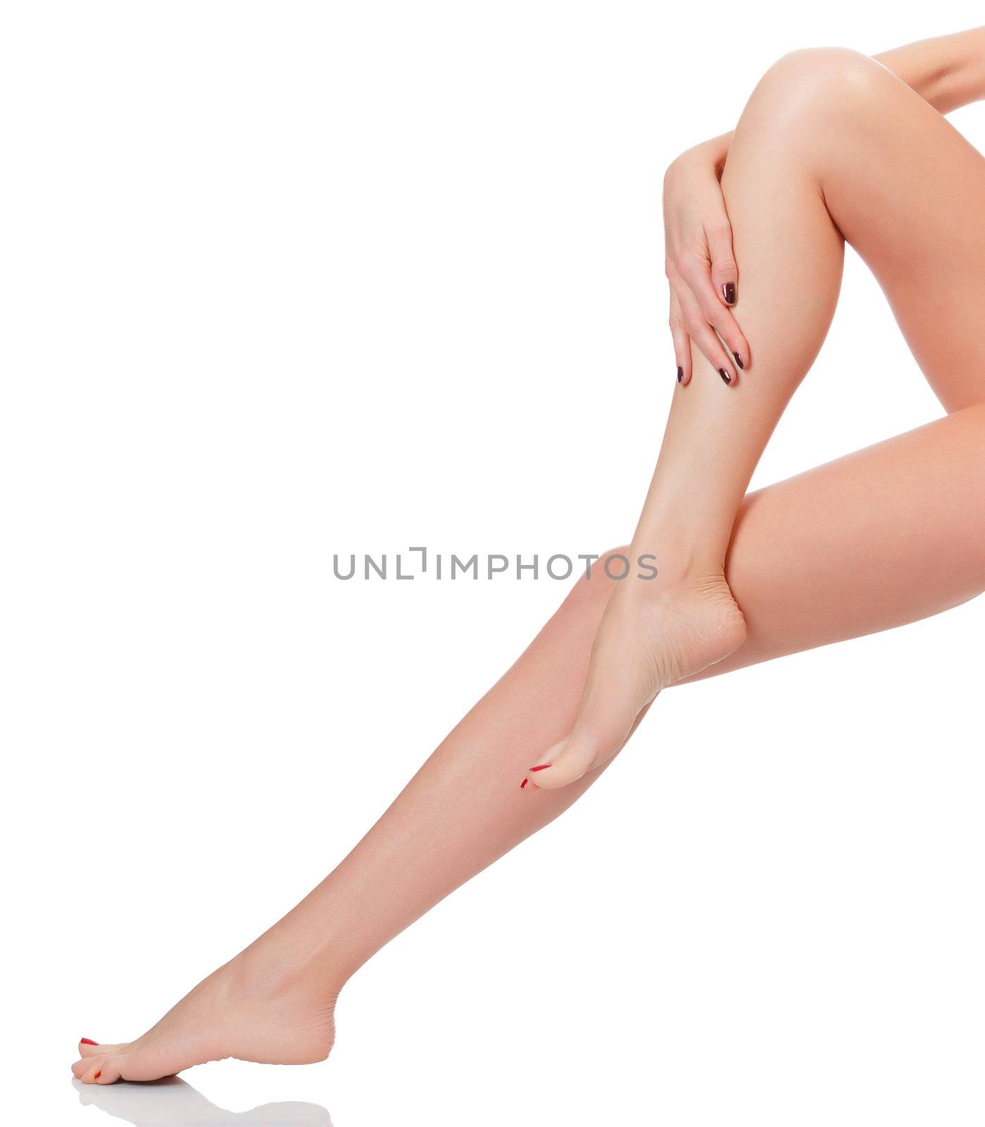 After depilation. Perfect long female legs against white background