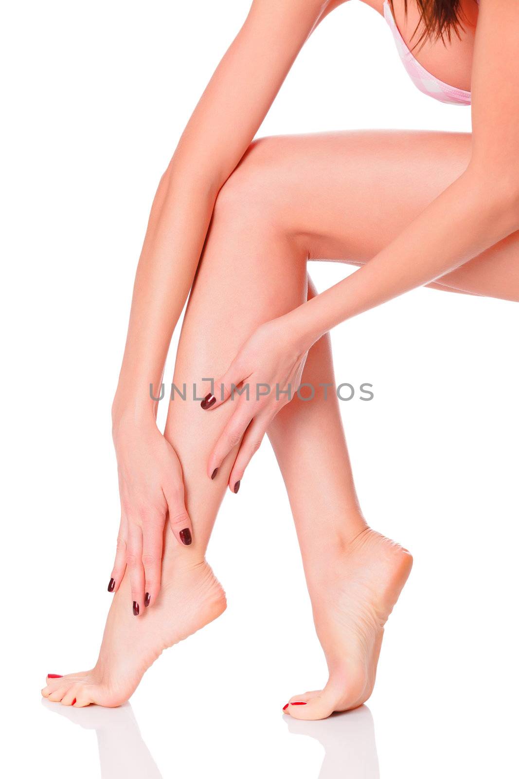 After depilation. Perfect long female legs against white background