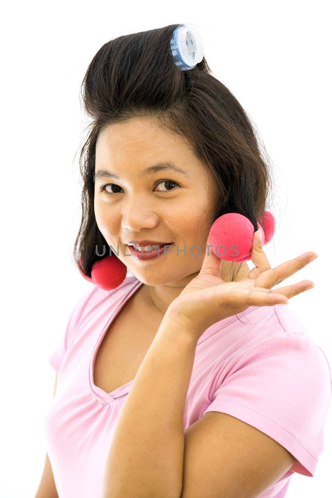 pretty young adult woman with hair curlers on white background