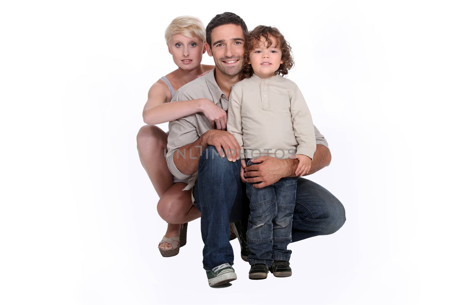 Young family posing in a studio