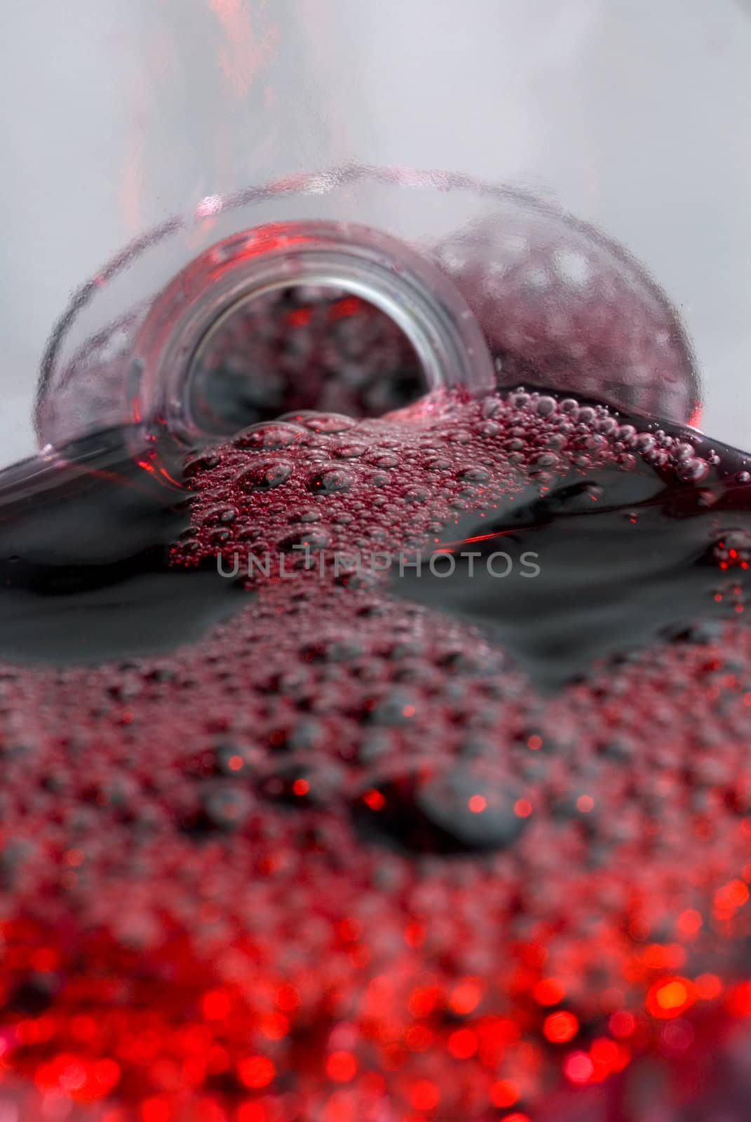 Wine pouring in a glass captured from unusual POV inside the bottle stock photo