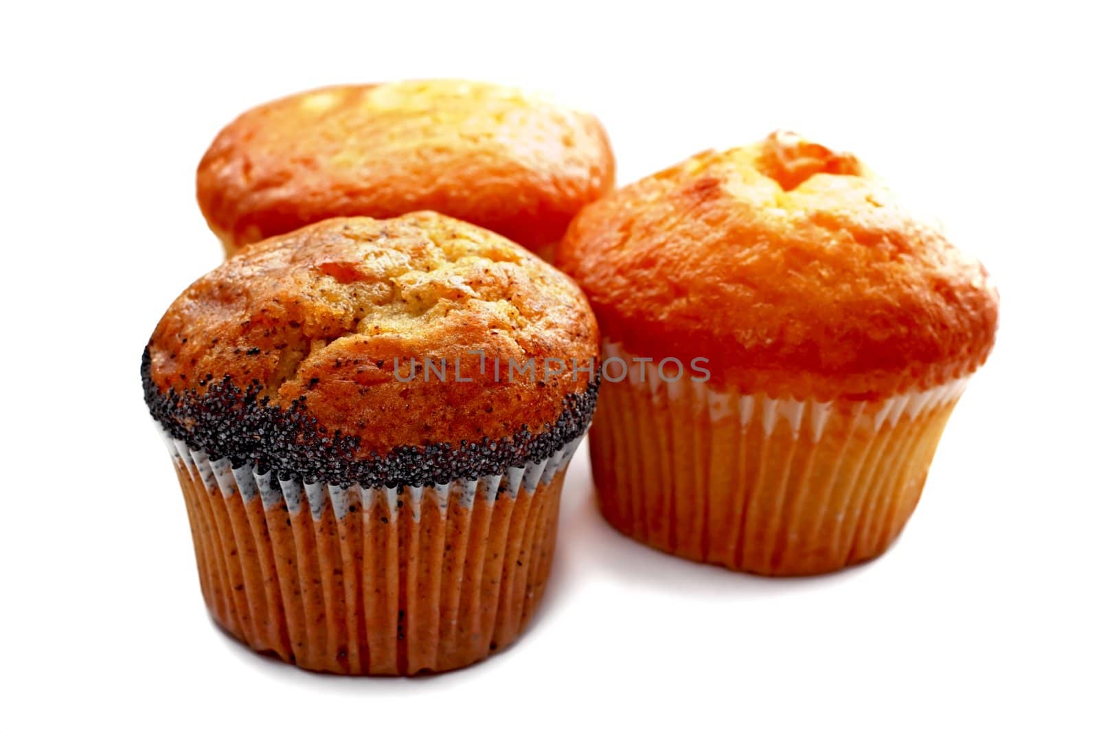 Three tasty muffins with poppies isolated on white background