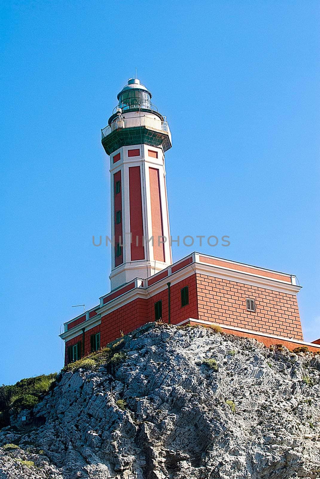 red lighthouse with blue skies, capri italy by itsrich