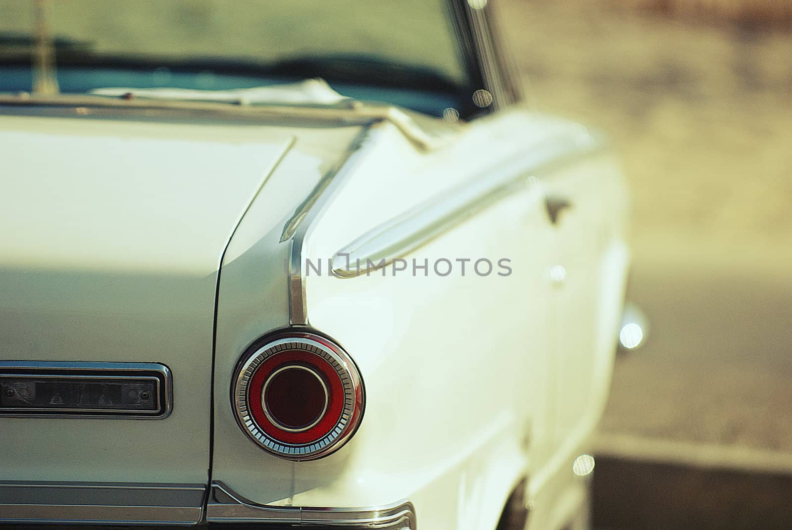 looking from behind, 1960's american convertible classic car at beach