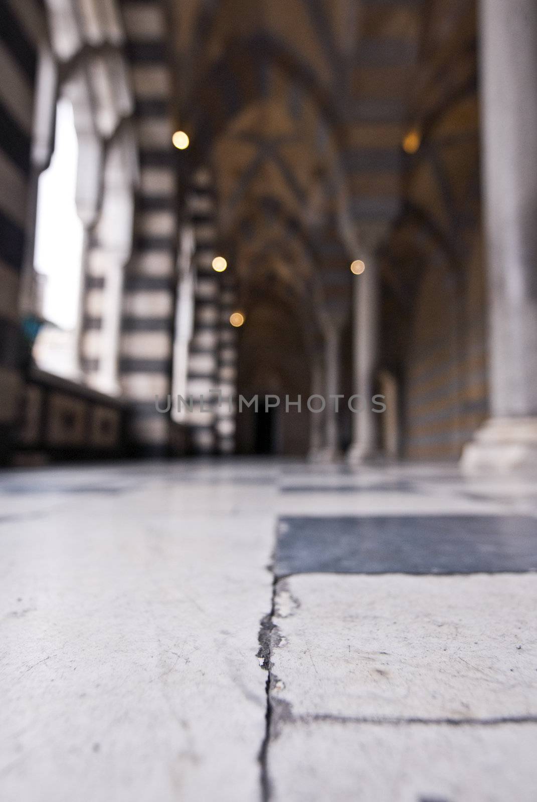patterned architecture columns and floor amalfi, italy with tour group in background by itsrich
