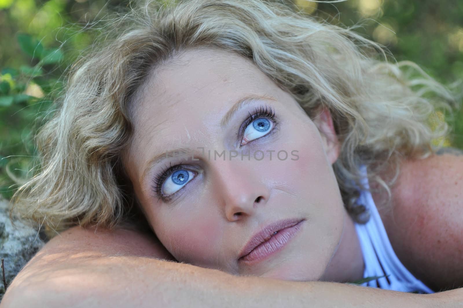 beautiful young woman with blue eyes in nature
