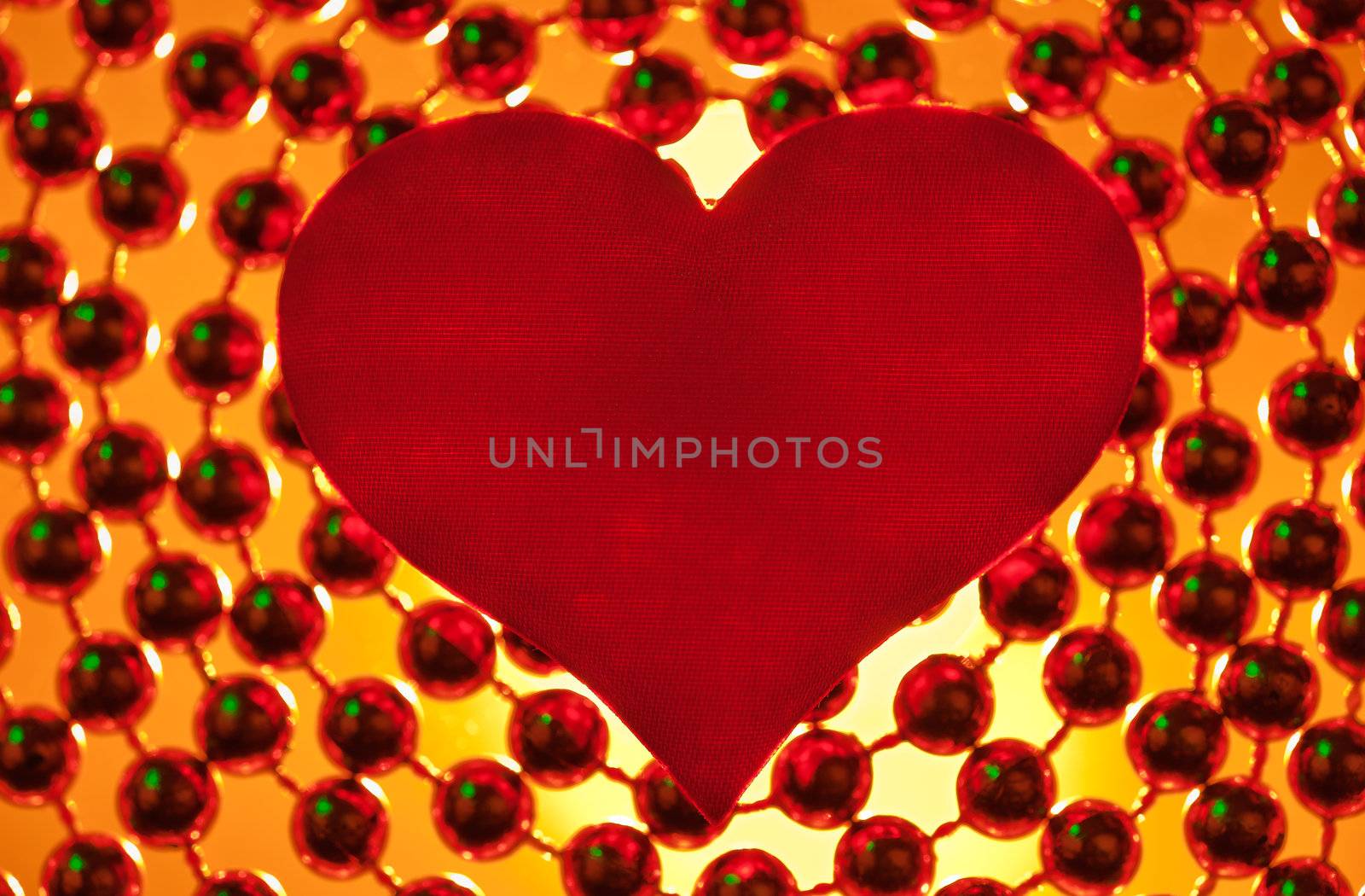 Silk red heart on a light background.