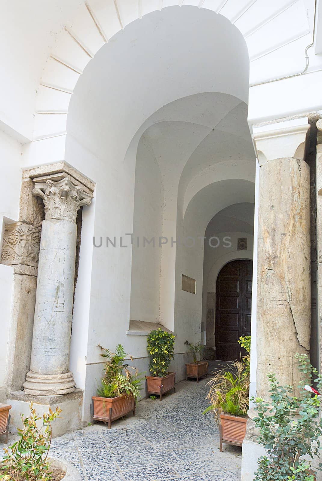 strong  white stucco arches leading to door, sorrento, italy