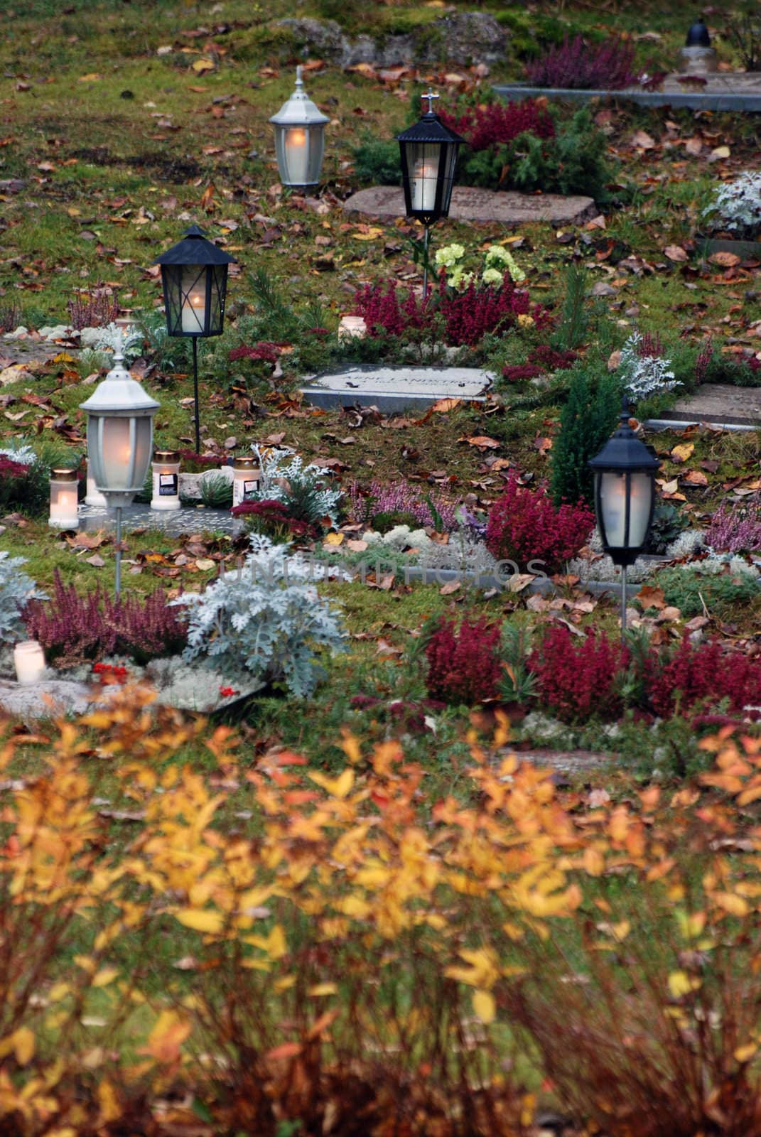 Graves at a cemetery where they lit candles to honor the dead