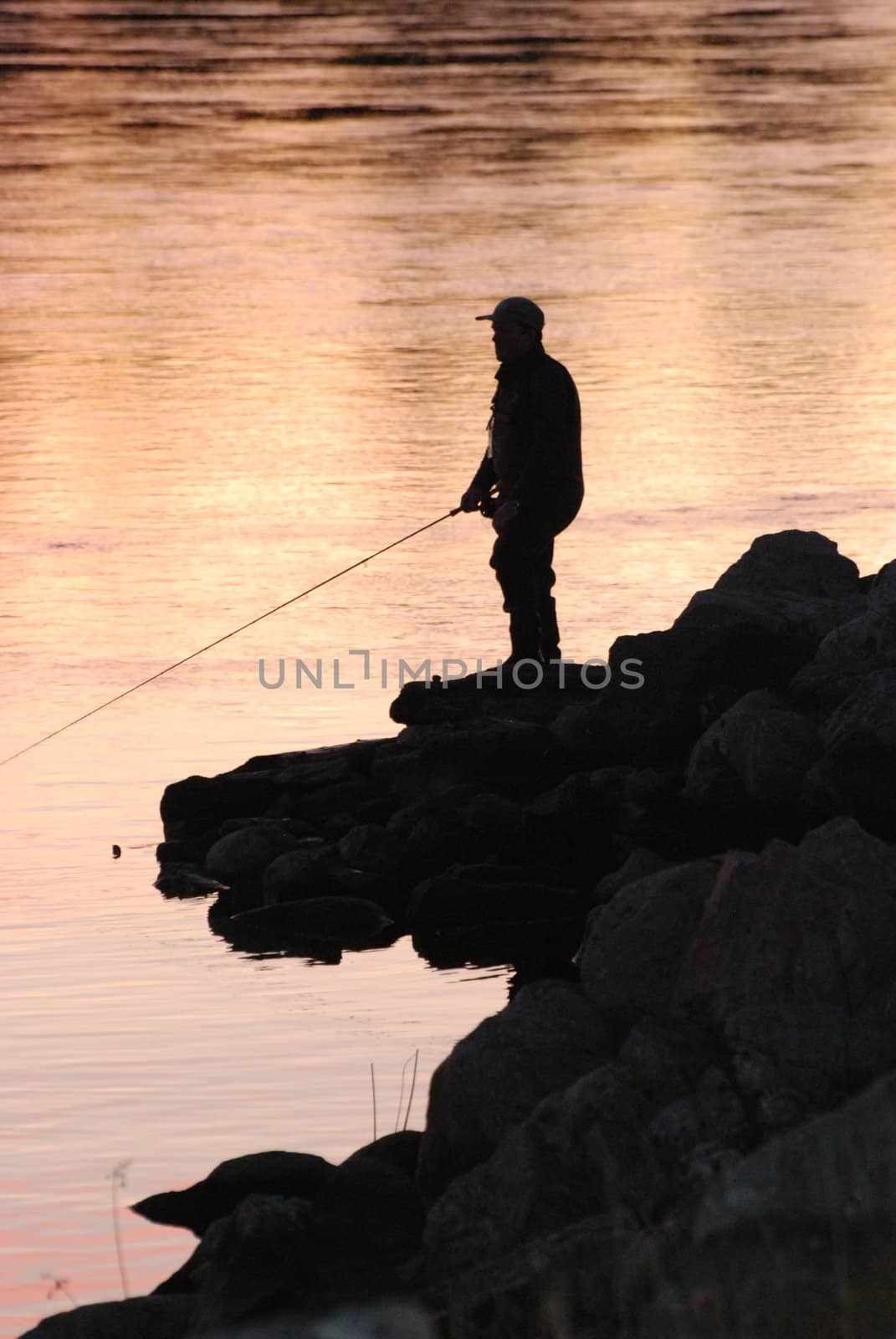 A fisherman in evening light