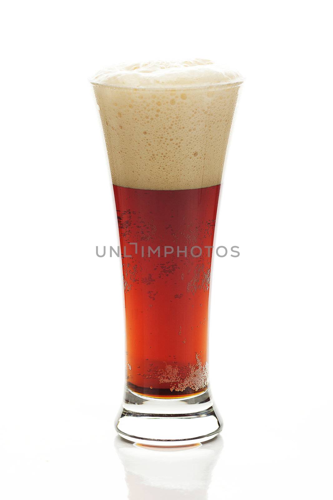 dark beer with the foam in a tall glass isolated on white