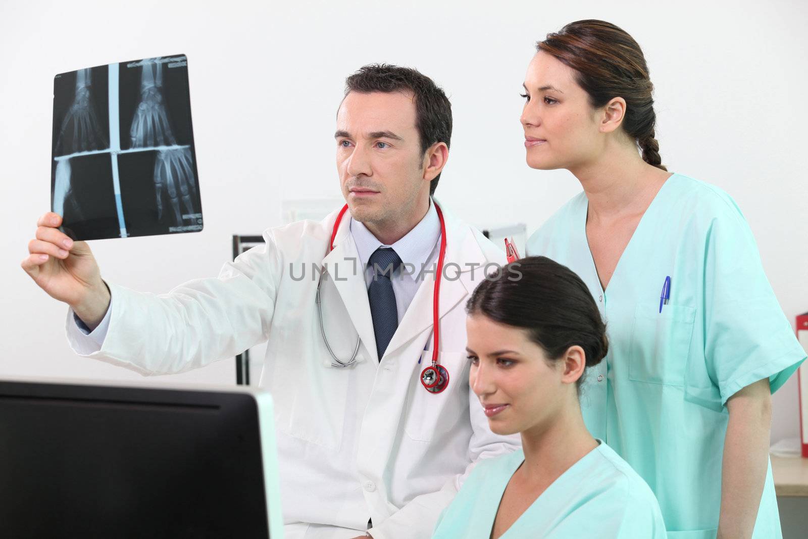 Doctors examining x-ray equipment