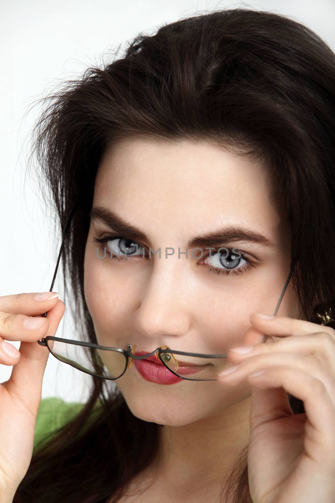 Beautiful woman wearing her glasses in a close up shot