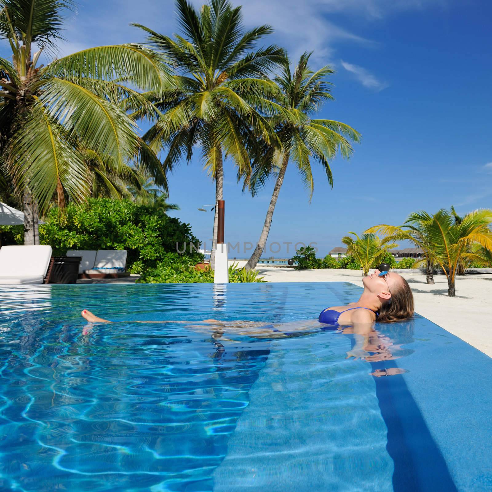 Woman at poolside by haveseen