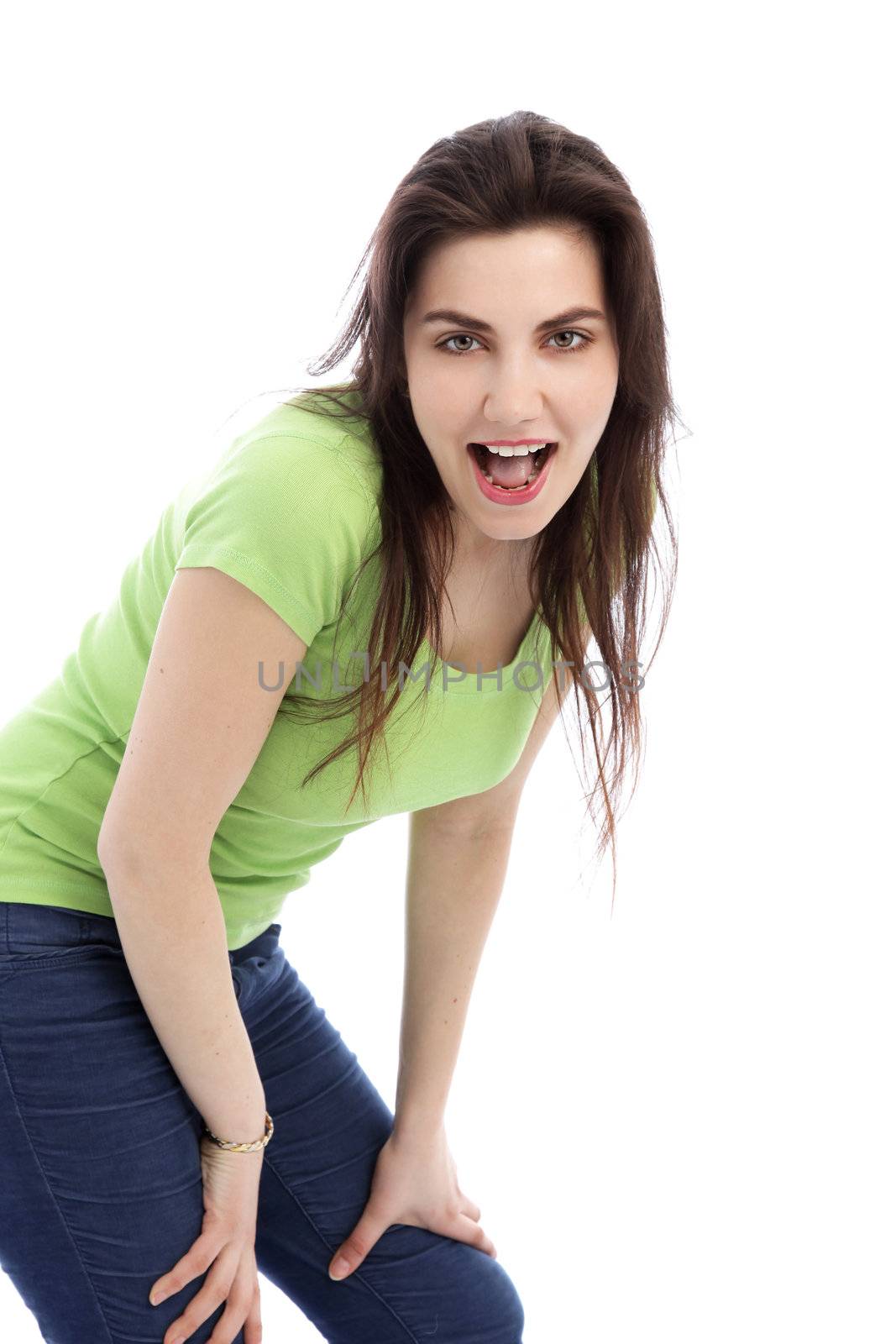 Brunette female in green shirt and jeans against the white background