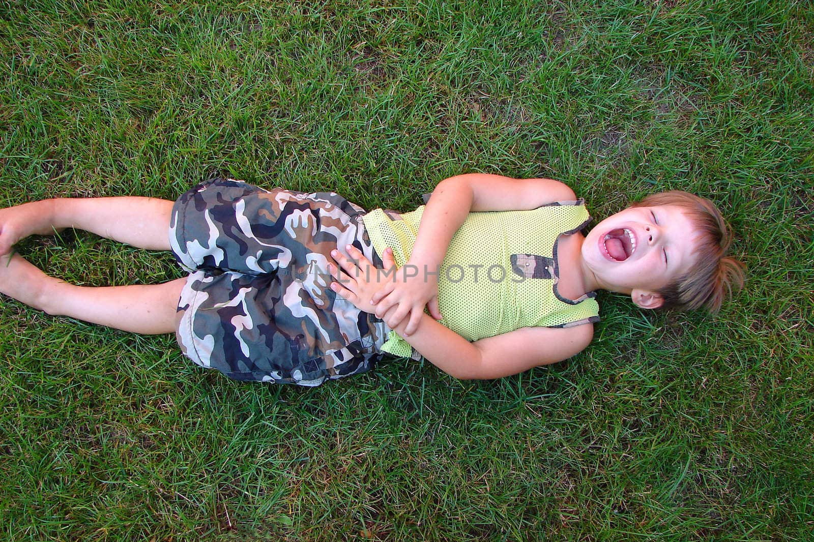 Baby laughing, lying on the by NickNick