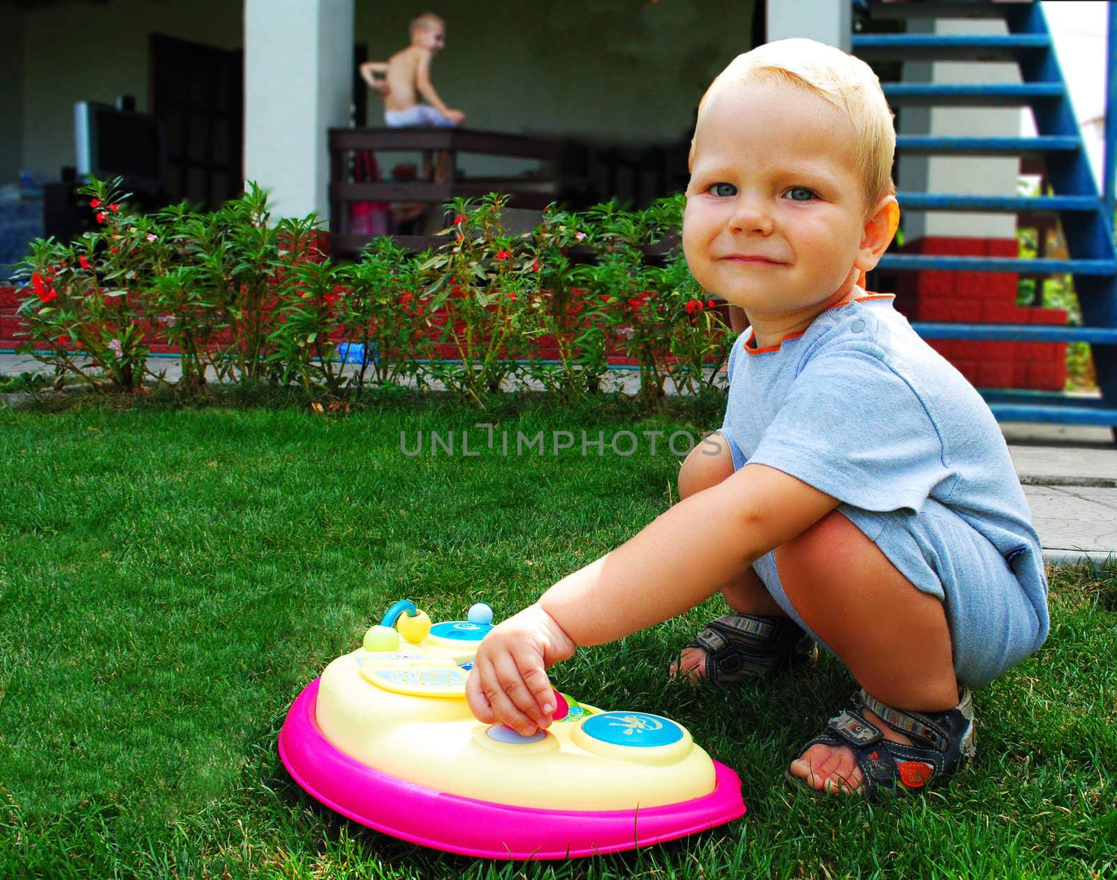 The kid plays on the front lawn by NickNick