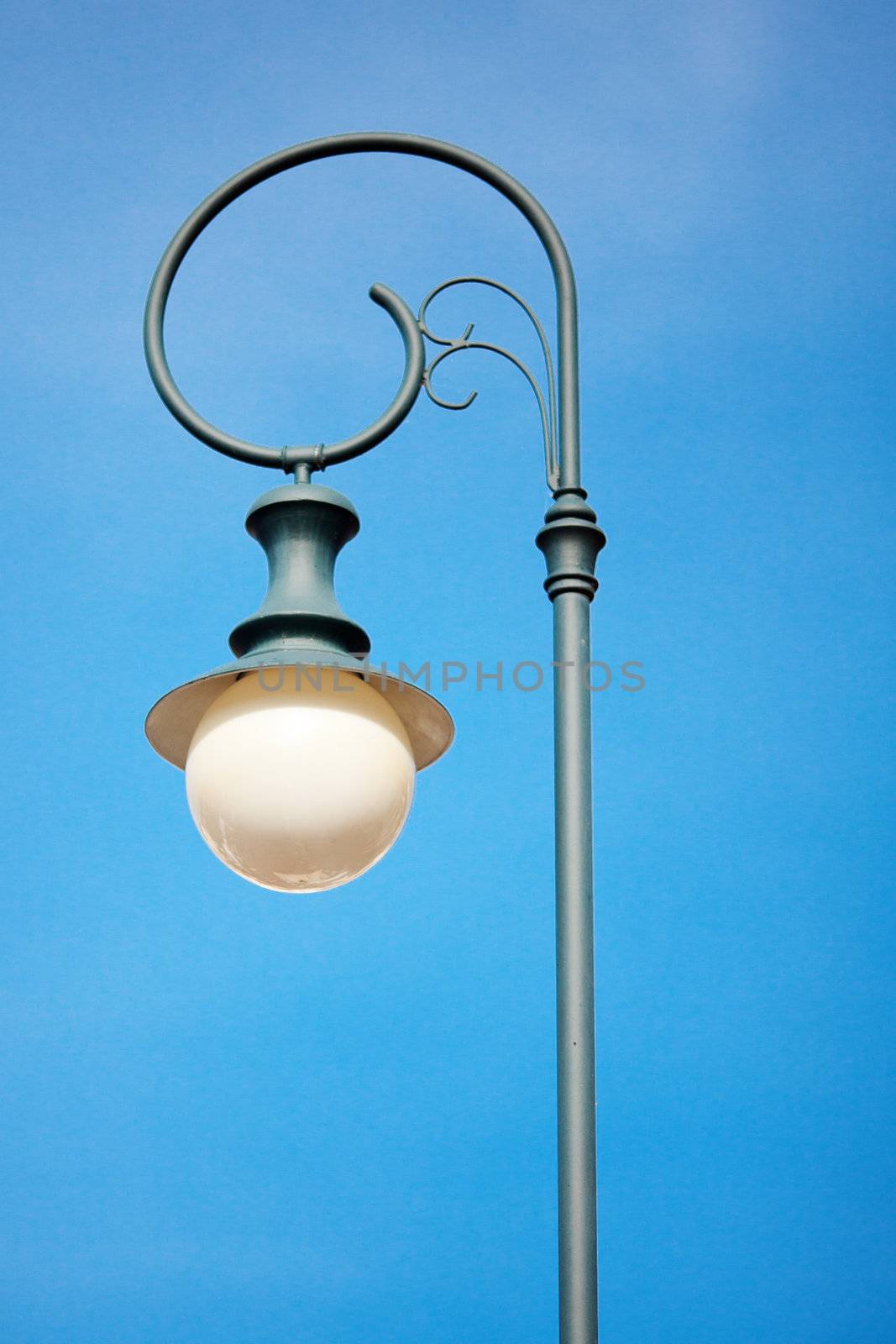 old lantern against the blue sky by jannyjus