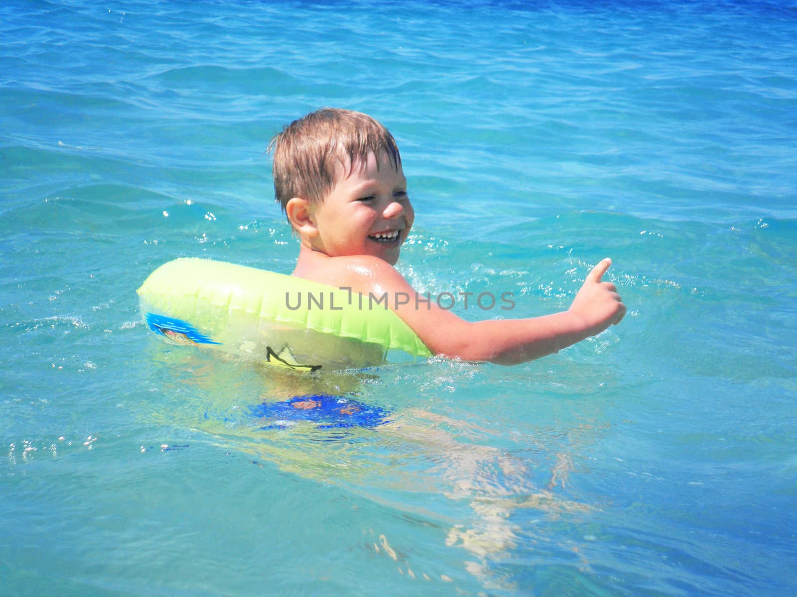 A boy swims in the sea by NickNick